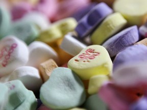 In this Jan. 14, 2009 file photo, colored "Sweethearts" candy is held in bulk prior to packaging at the New England Confectionery Company in Revere, Mass.  (AP Photo/Charles Krupa, File)