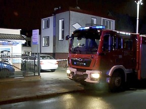 A fire engine stands outside an "Escape Room" game location in Koszalin, northern Poland, on Friday, Jan. 4, 2019. (AP Photo/TVN News via AP)