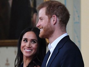 In this file photo taken on October 18, 2018 Britain's Prince Harry and Meghan, Duchess of Sussex attend a reception at Government House in Melbourne, Australia.