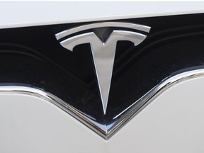 In this file photo taken on Dec. 20, 2016 the Tesla logo is seen in Washington, D.C.