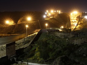 Floodlights from the U.S illuminate multiple border walls Monday, Jan. 7, 2019, seen from Tijuana, Mexico.