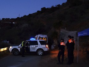 Emergency team members look for a boy after he fell into the 100-metre-deep waterhole in a mountainous area near the town of Totalan in Malaga, Spain, Monday, Jan. 14, 2019.