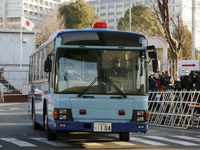 In this Tuesday, Jan. 8, 2019, file photo, a vehicle presumably carrying former Nissan chairman Carlos Ghosn leaves Tokyo Detention Center in Tokyo.