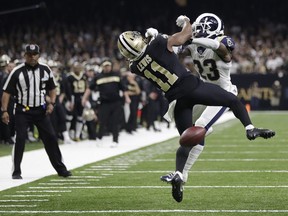 In this Sunday, Jan. 20, 2019 file photo, New Orleans Saints wide receiver Tommylee Lewis (11) works for a catch against Los Angeles Rams defensive back Nickell Robey-Coleman (23) in New Orleans.