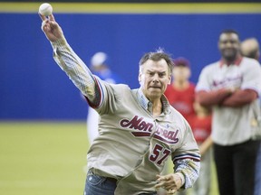 Former Montreal Expo pitcher John Wetteland throws out the first pitch before a spring training baseball game between the Toronto Blue Jays and St. Louis Cardinals on Monday, March 26, 2018 in Montreal.