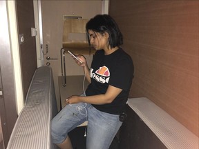 In this Monday, Jan. 7, 2019, photo released by Rahaf Mohammed Alqunun/Human Rights Watch, Rahaf Mohammed Alqunun views her mobile phone as she sits barricaded in a hotel room at an international airport in Bangkok, Thailand.