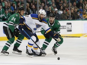 St. Louis Blues left wing Pat Maroon (7) tries to get the puck past Dallas Stars left wing Roope Hintz (24) and center Devin Shore (17) in Dallas, Saturday, Jan. 12, 2019.