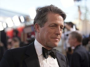 In this Sunday, Jan. 29, 2017 file photo, Hugh Grant arrives at the 23rd annual Screen Actors Guild Awards at the Shrine Auditorium & Expo Hall in Los Angeles.