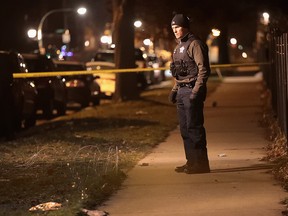 Police investigate the scene of a shooting where a 23-year-old woman was shot in the chest and hand and a 25-year-old man was shot in the leg on January 1, 2017 in Chicago. (Scott Olson/Getty Images)