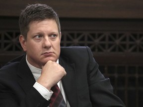 In this Thursday, Sept. 6, 2018, file photo, Chicago police Officer Jason Van Dyke, charged with first-degree murder in the shooting of black teenager Laquan McDonald in 2014, listens during a hearing at the Leighton Criminal Court Building in Chicago.