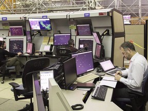 NAV Canada air traffic controllers monitor air traffic at the NAV Canada control centre in Montreal on March 2, 2018.