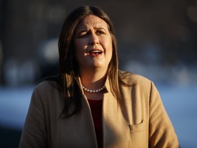 White House press secretary Sarah Huckabee Sanders talks with reporters outside the White House, Wednesday, Jan. 16, 2019, in Washington.