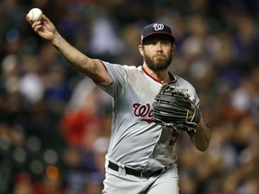 In this  Saturday, Sept. 29, 2018 file photo, Washington Nationals relief pitcher Greg Holland throws to first base to put out Colorado Rockies' DJ LeMahieu in the eighth inning of a baseball game in Denver. Two people familiar with the negotiations say reliever Greg Holland and the Arizona Diamondbacks have agreed to a $3.25 million, one-year contract. The people spoke to The Associated Press on condition of anonymity Wednesday, Jan. 30, 2019 because the agreement had not been announced.