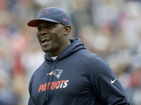 In this Sept. 9, 2018, file photo, New England Patriots linebackers coach Brian Flores watches his team warm up before an NFL football game against the Houston Texans, in Foxborough, Mass.