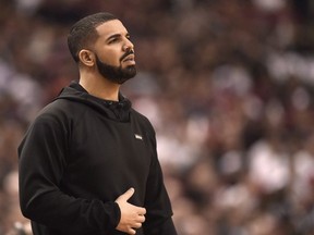 Rapper Drake watches the action between the Indiana Pacers and the Toronto Raptors during first half NBA playoff basketball action in Toronto on Tuesday, April 26, 2016.