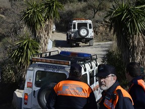 Emergency services look for a 2-year-old boy who fell into a well, in a mountainous area near the town of Totalan in Malaga, Spain, Monday, Jan. 14, 2019.