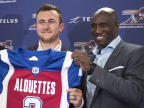 GM Kavis Reed helps new Montreal Alouettes newest quarterback Johnny Manziel hold up his jersey in July 2018. Reed says the Als have lots of options at quarterback for 2019.