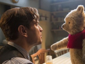 This image released by Disney shows Ewan McGregor in a scene from "Christopher Robin." Tom Cruise has outrun Winnie-the-Pooh at the box office.
