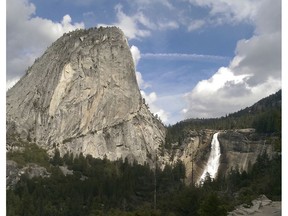 In this March 28, 2016, file photo provided by the National Park Service, water flows over the Nevada Fall near Liberty Cap as seen from the John Muir Trail in Yosemite National Park, Calif. The National Park Service says a man died after falling into a river at Yosemite National Park on Christmas Day. A government spokesman says rangers responding to a 911 call arrived on scene in less than an hour and provided medical aid, but the man died from a head injury. The park says an investigation into the death is taking longer than usual because of the partial government shutdown. (National Park Service via AP, File) ORG XMIT: LA507