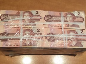 A bundle of old Canada $2 bills is shown in a handout photo. Thieves made off with what police say is a "significant quantity" of Canadian currency -- all in one-and two-dollar bills -- from a store in Moncton, N.B. THE CANADIAN PRESS/HO-Codiac RCMP MANDATORY CREDIT
