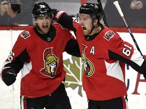 Senators forwards Colin White, left, and Mark Stone celebrate Stone's third-period goal against Washington on Saturday night. They have played well together, but were skating on different lines during practice on Sunday.