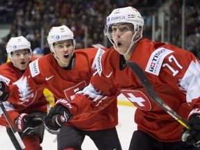Switzerland's Luca Wyss, right, celebrates his goal against Sweden on Wednesday in Victoria with teammates Sandro Schmid and Matthew Verboon.