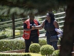 A unidentified relative is helped by a Red Cross worker as she grieves after visiting the morgue in Nairobi, Kenya Thursday, Jan. 17, 2019. Extremists stormed a luxury hotel complex in Kenya's capital on Tuesday, setting off thunderous explosions and gunning down people at cafe tables in an attack claimed by Africa's deadliest Islamic militant group al-Shabab.