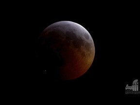 This image from video provided by Griffith Observatory in Los Angeles shows an impact flash on the moon, bottom left, during the lunar eclipse which started on Sunday evening, Jan. 20, 2019.