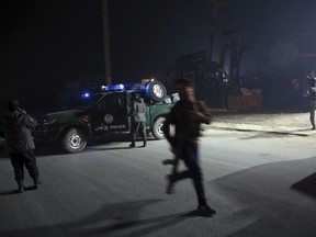 Policemen block the road near the site of a suicide attack in Kabul, Afghanistan, Monday, Jan. 14, 2019. Afghan officials say multiple people were killed when a suicide bomber detonated a vehicle full of explosive in the capital Kabul on Monday.