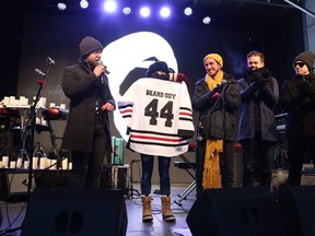 Members of Walk Off the Earth hold a jersey donated by the Burlington Sound of Music Festival that is lettered for Mike "Beard Guy" Taylor Walk Off The Earth Memorial & Tribute Concert for Mike "Beard Guy" Taylor in Burlington, Ont., on Sunday, January 13th, 2019. Acoustic performances by members of Barenaked Ladies, Scott Helman, Monster Truck, USS and more were also scheduled for the event.