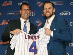 New York Mets General Manager Brodie Van Wagenen, left, poses for a photograph with All-Star infielder Jed Lowrie after Lowrie signed with the Mets, Wednesday, Jan. 16, 2019, in New York.