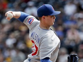 In this Aug. 19, 2018, file photo, Chicago Cubs relief pitcher Justin Wilson throws against the Pittsburgh Pirates in a baseball gam in Pittsburgh.