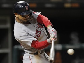 In this Thursday, Aug. 30, 2018, file photo, Boston Red Sox's Mookie Betts hits a two-run home run against the Chicago White Sox during the seventh inning of a baseball game in Chicago.