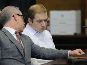 James Jackson, right, confers with his lawyer during a hearing in criminal court, Wednesday Jan. 23, 2019 in New York. Jackson, a white supremacist, pled guilty Wednesday, to killing a black man with a sword as part of a racist plot that prosecutors described as a hate crime.  He faces life in prison when he is sentenced on Feb. 13.