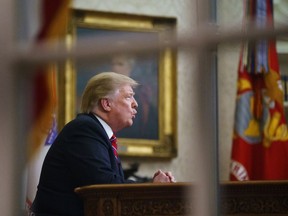 In this Tuesday, Jan. 8, 2019, file photo seen from a window outside the Oval Office, President Donald Trump gives a prime-time address about border security at the White House in Washington.