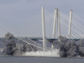 A section of the old Tappan Zee Bridge is brought down with explosives in this view from Tarrytown, N.Y., Tuesday, Jan. 15, 2019.