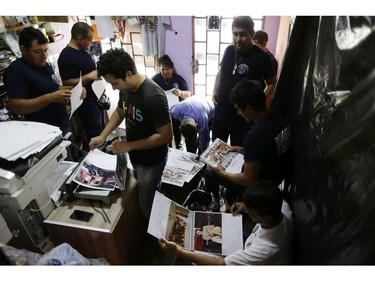In this Jan. 12, 2019 photo, firefighters work putting calendars together in Asuncion, Paraguay. The San Roque Gonzalez fire station gets about $600 a month to serve the 16,000 residents of the town.