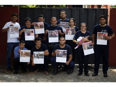 In this Jan. 12, 2019 photo, the firefighters of San Roque Gonzalez pose for a group photo before going out in the streets to sell calendars, in Asuncion, Paraguay.