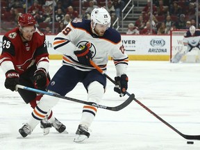 Edmonton Oilers centre Leon Draisaitl tries to keep the puck away from Arizona Coyotes centre Nick Cousins during the first period of an NHL hockey game Wednesday, Jan. 2, 2019, in Glendale, Ariz.