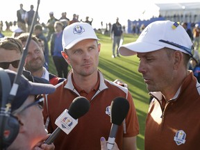In this Sept. 29, 2018 file photo, Europe's Justin Rose, middle, and Henrik Stenson are interviewed after winning a foursome match on the second day of the Ryder Cup at Le Golf National in Saint-Quentin-en-Yvelines, France. (AP Photo/Matt Dunham, File)
