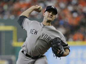 In this Saturday, Oct. 14, 2017 file photo, New York Yankees relief pitcher David Robertson throws during the seventh inning of Game 2 of baseball's American League Championship Series against the Houston Astros in Houston.