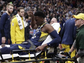Indiana Pacers guard Victor Oladipo is taken off the court on a stretcher after he was injured during the first half of the team's NBA basketball game against the Toronto Raptors in Indianapolis, Wednesday, Jan. 23, 2019.