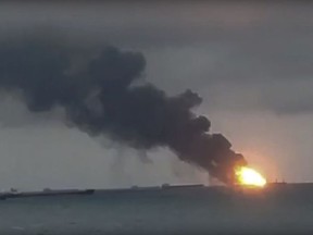 In this video grab provided by the Kerch.fm web portal, the two vessels, the Maestro and the Candiy, on fire near the Kerch Strait linking the Black Sea and the Sea of Azov, in Kerch, Crimea, Monday, Jan. 21, 2019.  Two Tanzanian-flagged commercial vessels caught fire in the Black Sea, leaving at least 10 sailors dead, Russian officials said, and seven sailors are reported still missing. (Kerch.fm via AP)