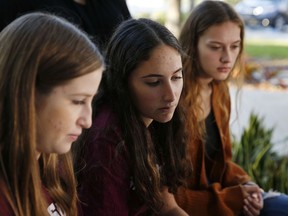In this Wednesday, Jan. 16, 2019, photo, Brianna Fisher, 16, left, Leni Steinhardt, 16, centre, and Brianna Jesionowski sit during an interview with The Associated Press about a new book called "Parkland Speaks: Survivors from Marjory Stoneman Douglas Share Their Stories," in Parkland, Fla.