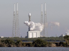 A Falcon 9 SpaceX rocket, stands ready at space launch complex 40, shortly before the launch was scrubbed because of a technical issue at the Cape Canaveral Air Force Station in Cape Canaveral, Fla., Tuesday, Dec. 18, 2018.