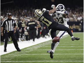 In this Sunday, Jan. 20, 2019 file photo, New Orleans Saints wide receiver Tommylee Lewis (11) works for a catch against Los Angeles Rams defensive back Nickell Robey-Coleman (23) during the second half the NFL football NFC championship game, in New Orleans.