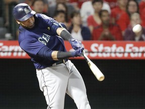 In this Sept. 13, 2018, file photo, Seattle Mariners' Nelson Cruz watches his three-run home run against the Los Angeles Angels, in Anaheim, Calif. (AP Photo/Chris Carlson, File)