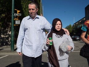 John Nuttall, left, and Amanda Korody leave jail after being re-arrested and placed under a peace bond and released again, after a judge ruled the couple were entrapped by the RCMP in a police-manufactured crime, in Vancouver on Friday, July 29, 2016.