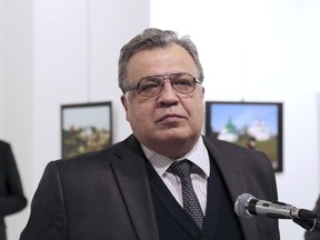 In this Monday, Dec. 19, 2016 file photo, Andrei Karlov, then Russian Ambassador to Turkey, pauses during a speech at a photo exhibition in Ankara.