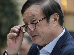 Ren Zhengfei, founder and CEO of Huawei, adjusts his glasses during a round table meeting with the media in Shenzhen city, south China's Guangdong province, Tuesday, Jan. 15, 2019.